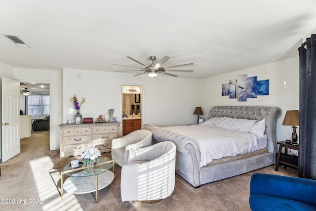 carpeted bedroom featuring ceiling fan and connected bathroom