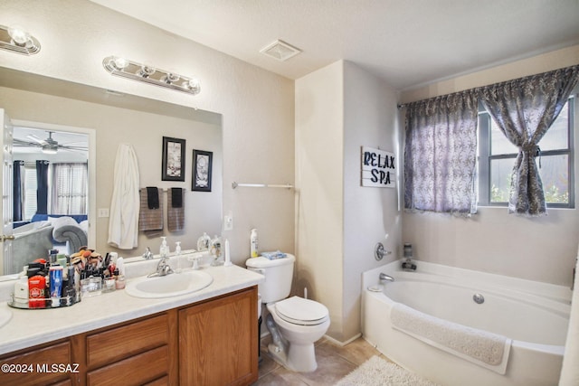 bathroom featuring vanity, tile patterned floors, a washtub, ceiling fan, and toilet