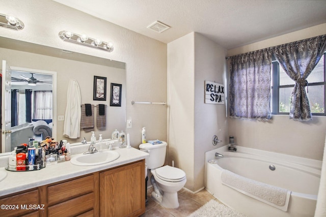 bathroom with a tub, ceiling fan, tile patterned floors, toilet, and vanity