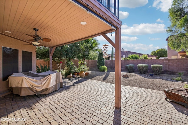 view of patio / terrace with ceiling fan and a balcony