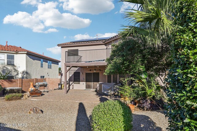 3457 N Crystal Hill Ave, Tucson, AZ 85745 - back of property with a balcony, roof mounted solar panels, a patio area, ceiling fan, and stucco siding