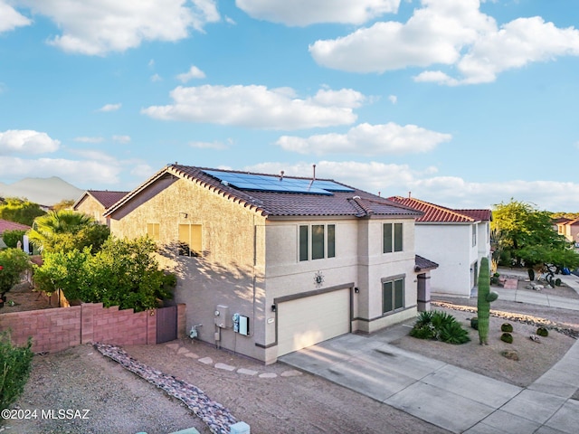 view of front of house with solar panels and a garage