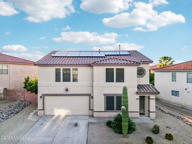 3457 N Crystal Hill Ave, Tucson, AZ 85745 - view of front of home with a tile roof, an attached garage, and solar panels