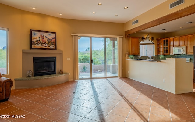 unfurnished living room featuring light tile patterned floors