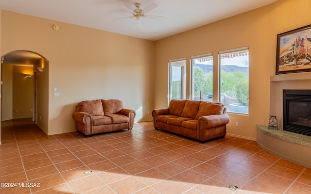 living room featuring ceiling fan and light tile patterned floors