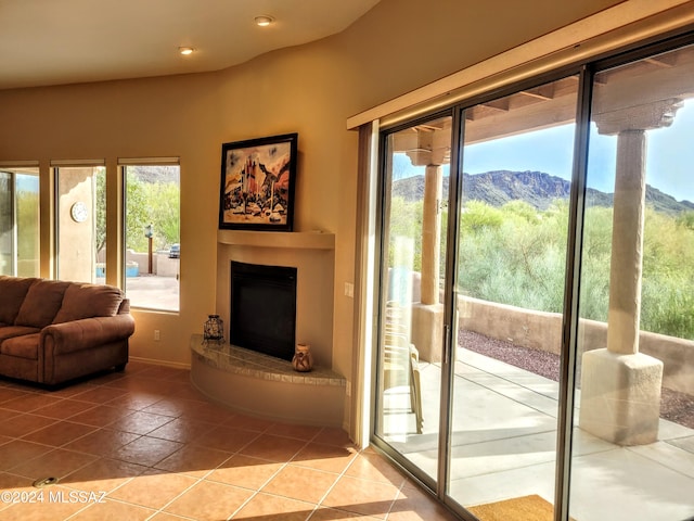 doorway to outside featuring tile patterned flooring, a mountain view, and a wealth of natural light