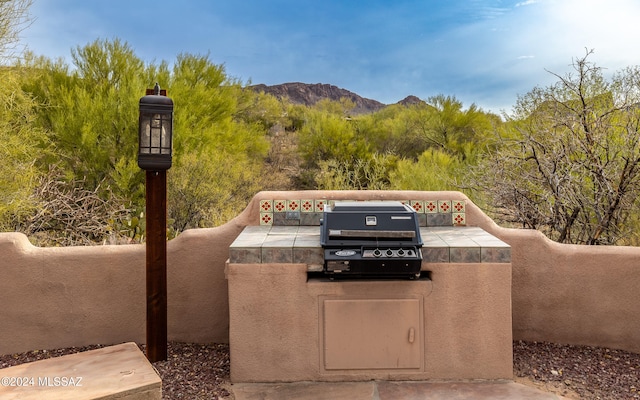 view of patio / terrace with a mountain view and area for grilling