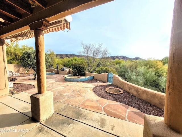 view of patio / terrace featuring a mountain view