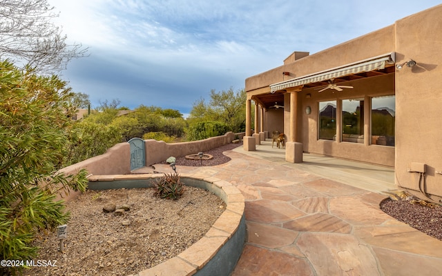 view of yard with a patio area and ceiling fan