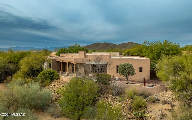 rear view of house featuring a mountain view