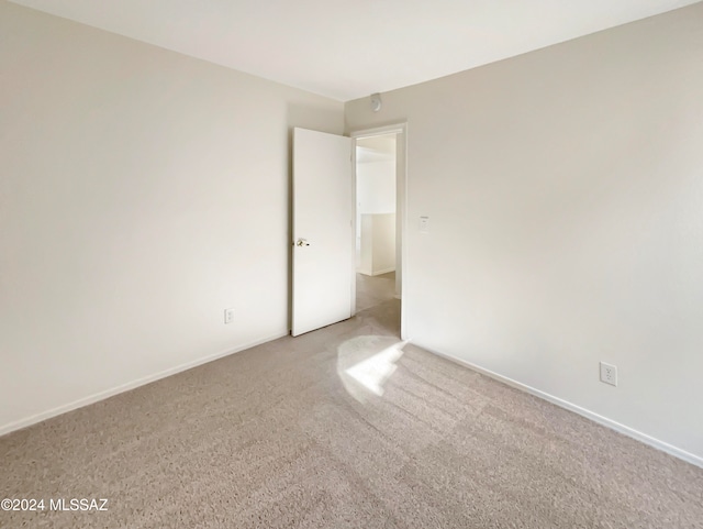 unfurnished room with light carpet