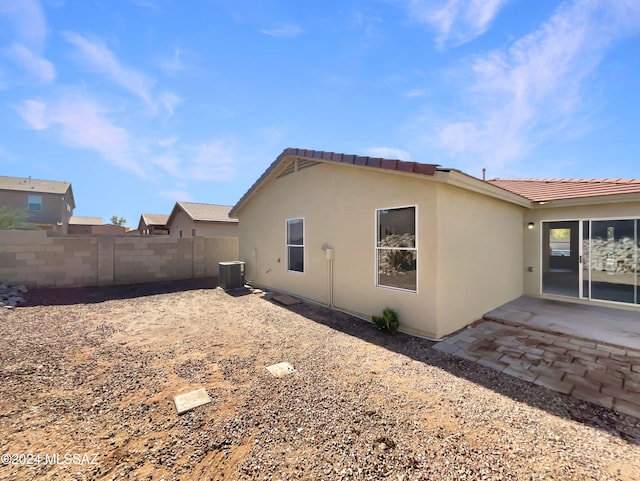 view of home's exterior with a patio area and cooling unit