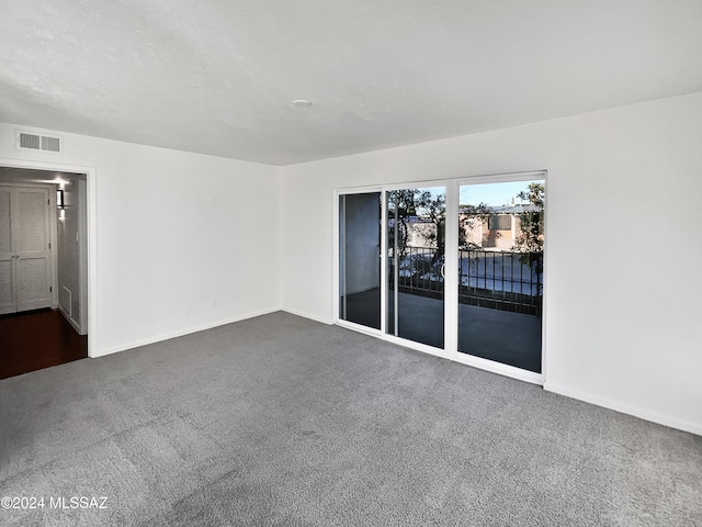 empty room featuring dark colored carpet