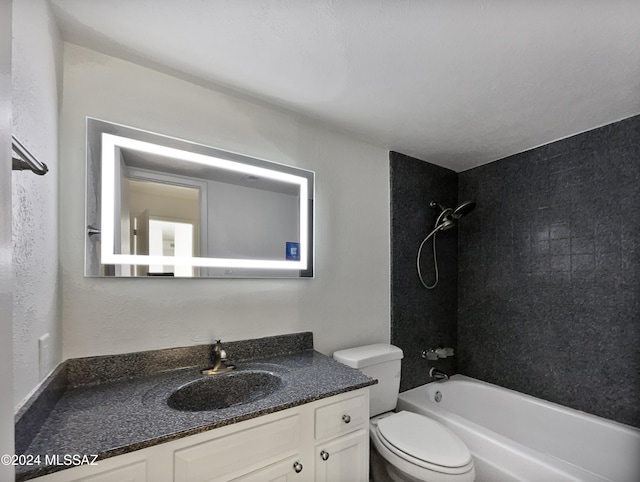 full bathroom with toilet, vanity, and tiled shower / bath combo