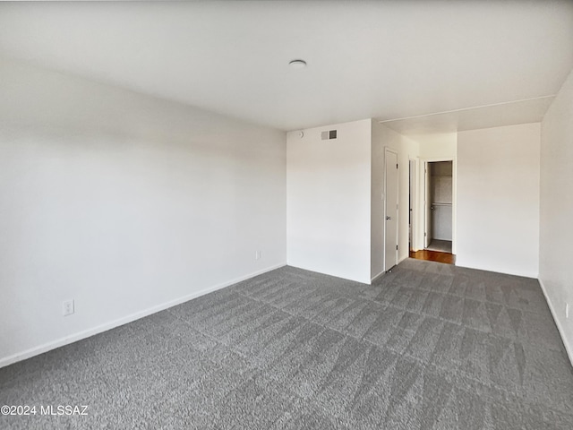 1600 N Wilmot Rd Unit 291, Tucson, AZ 85712 - unfurnished room with dark carpet and baseboards