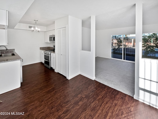 kitchen featuring white cabinets, stainless steel appliances, dark wood-type flooring, and sink