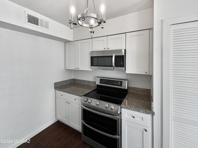 1600 N Wilmot Rd Unit 291, Tucson, AZ 85712 - kitchen with appliances with stainless steel finishes, baseboards, white cabinets, and a chandelier