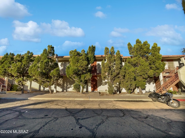1600 N Wilmot Rd Unit 291, Tucson, AZ 85712 - obstructed view of property featuring stairway and stucco siding