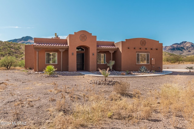 pueblo-style house with a mountain view