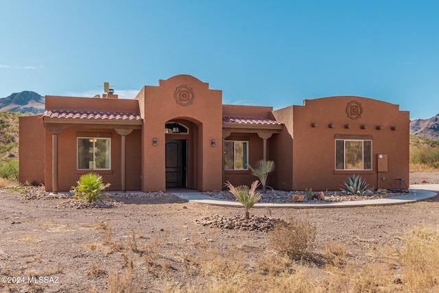 adobe home featuring a mountain view