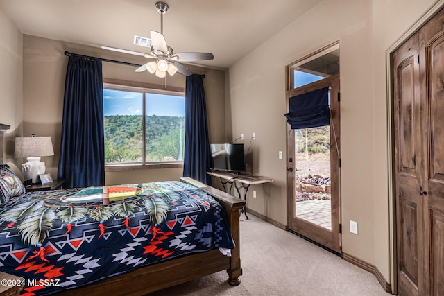 carpeted bedroom with ceiling fan and access to outside