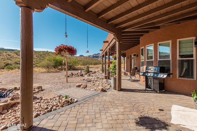 view of patio with a mountain view and area for grilling