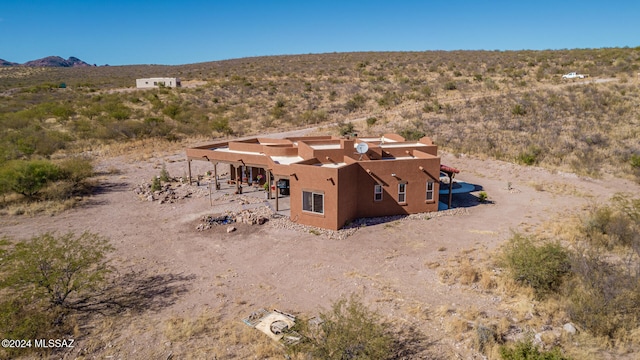 birds eye view of property with a mountain view