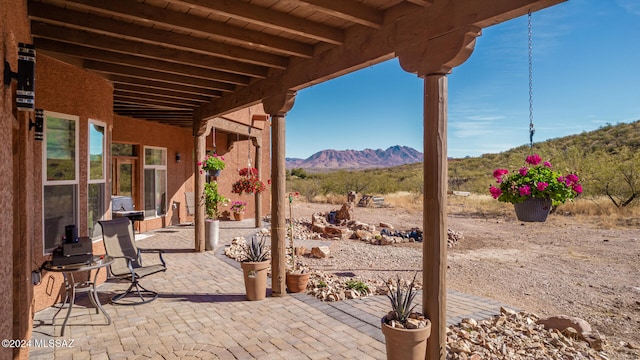 view of patio / terrace featuring a mountain view