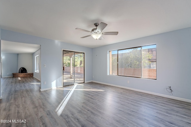 empty room featuring hardwood / wood-style flooring and ceiling fan