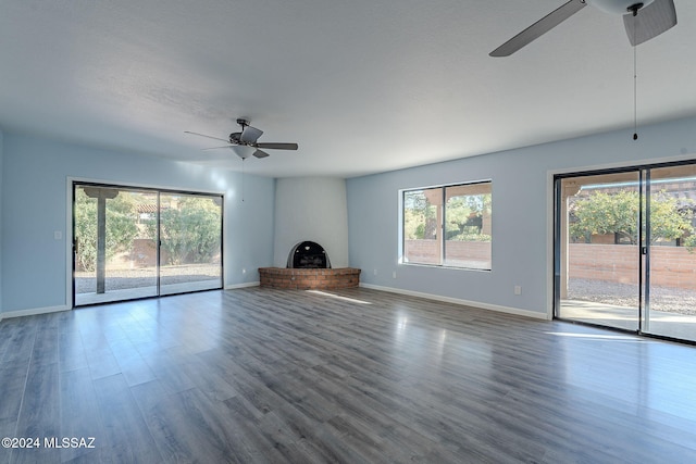 unfurnished living room with a fireplace, hardwood / wood-style flooring, and ceiling fan