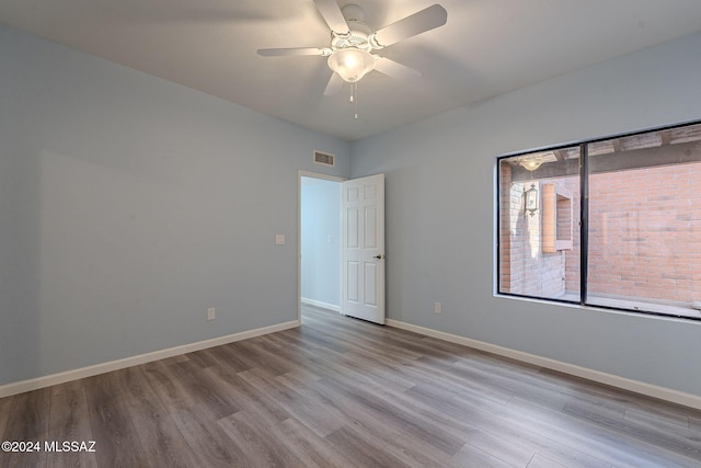 spare room featuring ceiling fan and light hardwood / wood-style flooring