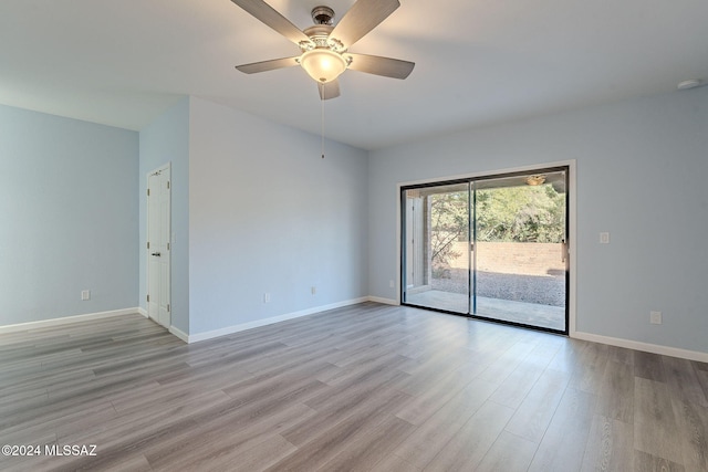 empty room with ceiling fan and light wood-type flooring