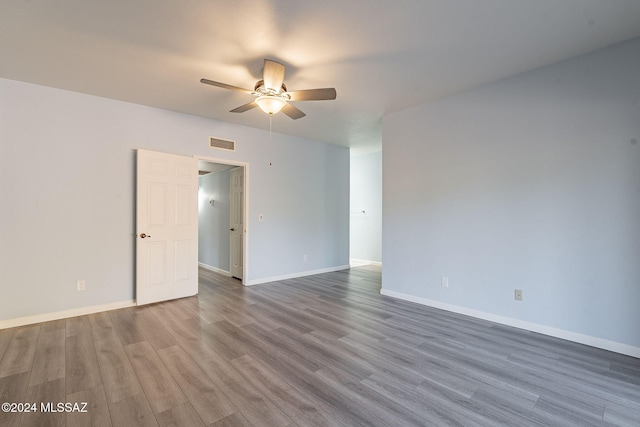 spare room with hardwood / wood-style floors and ceiling fan