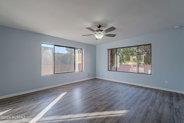 spare room featuring dark hardwood / wood-style flooring and ceiling fan