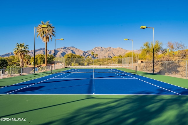 view of sport court featuring a mountain view and basketball court