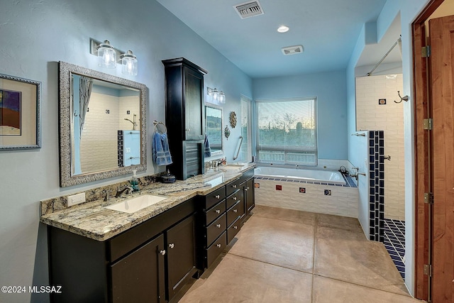 bathroom featuring tile patterned flooring, vanity, and shower with separate bathtub