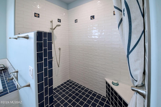 bathroom with a tile shower