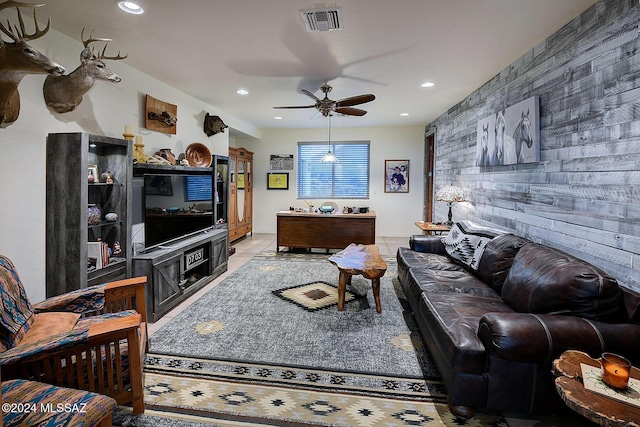 living room featuring ceiling fan and light tile patterned floors