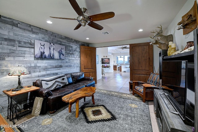 living room featuring wooden walls and light tile patterned floors