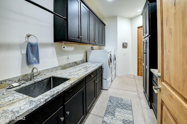 laundry area featuring cabinets, independent washer and dryer, and sink