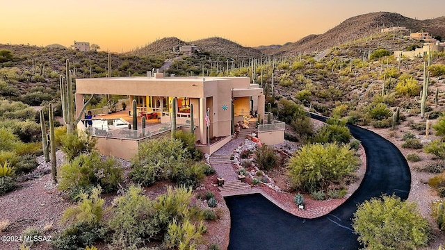 back house at dusk featuring a mountain view