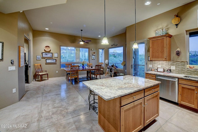 kitchen with hanging light fixtures, stainless steel dishwasher, ceiling fan, decorative backsplash, and a kitchen island