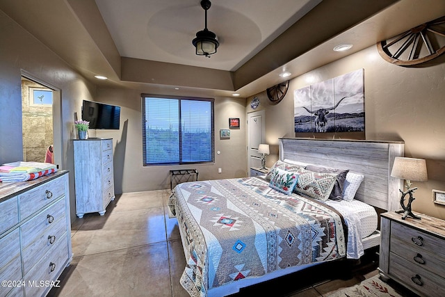 bedroom featuring ceiling fan and a tray ceiling