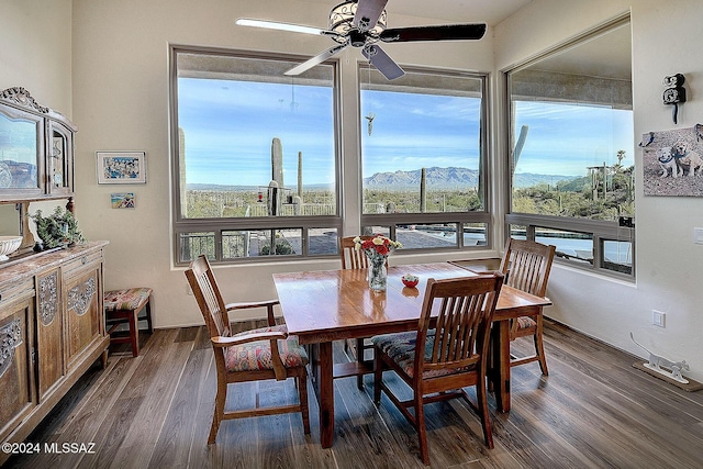 dining room with a mountain view, dark hardwood / wood-style floors, and ceiling fan