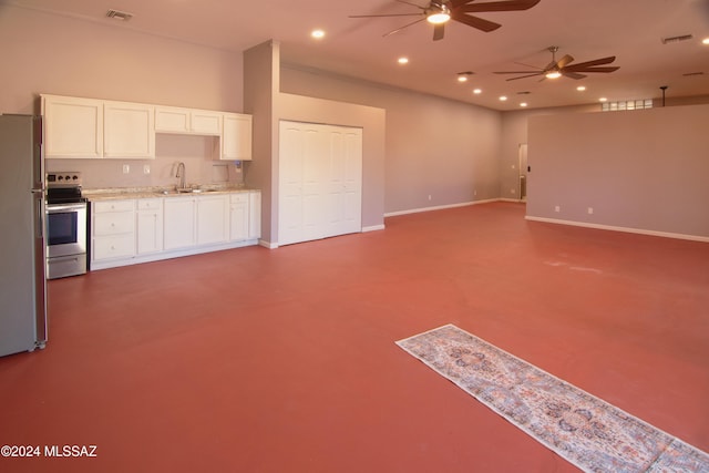 unfurnished living room with ceiling fan and sink