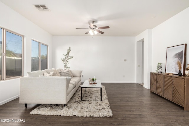 living room with ceiling fan and dark wood-type flooring