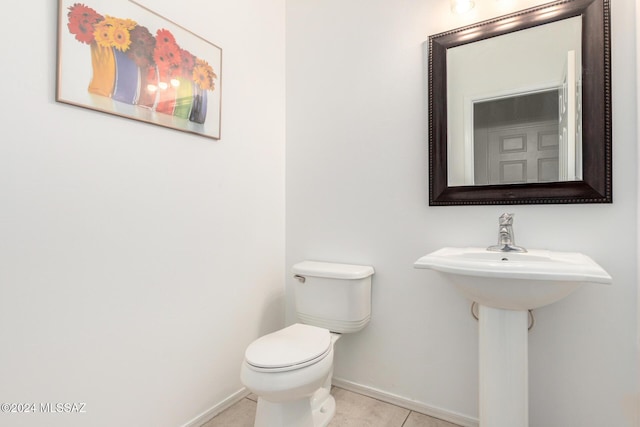 bathroom featuring tile patterned flooring and toilet