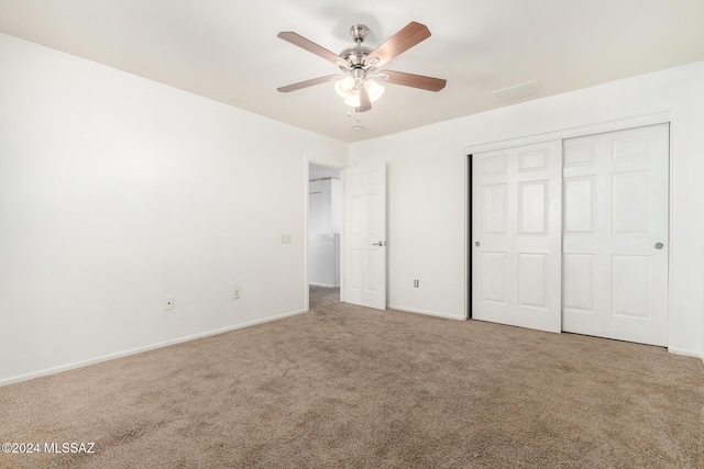 unfurnished bedroom with carpet floors, a closet, and ceiling fan