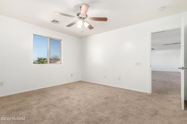 carpeted spare room with ceiling fan