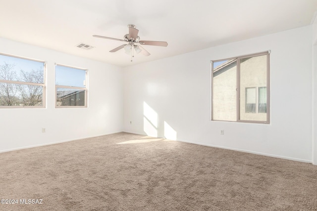 unfurnished room with carpet and ceiling fan